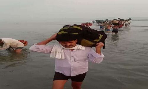 जान हथेली पर लेकर घर लौट रहे मजदूर, सिर पर समान रख यमुना नदी कर रहें पार